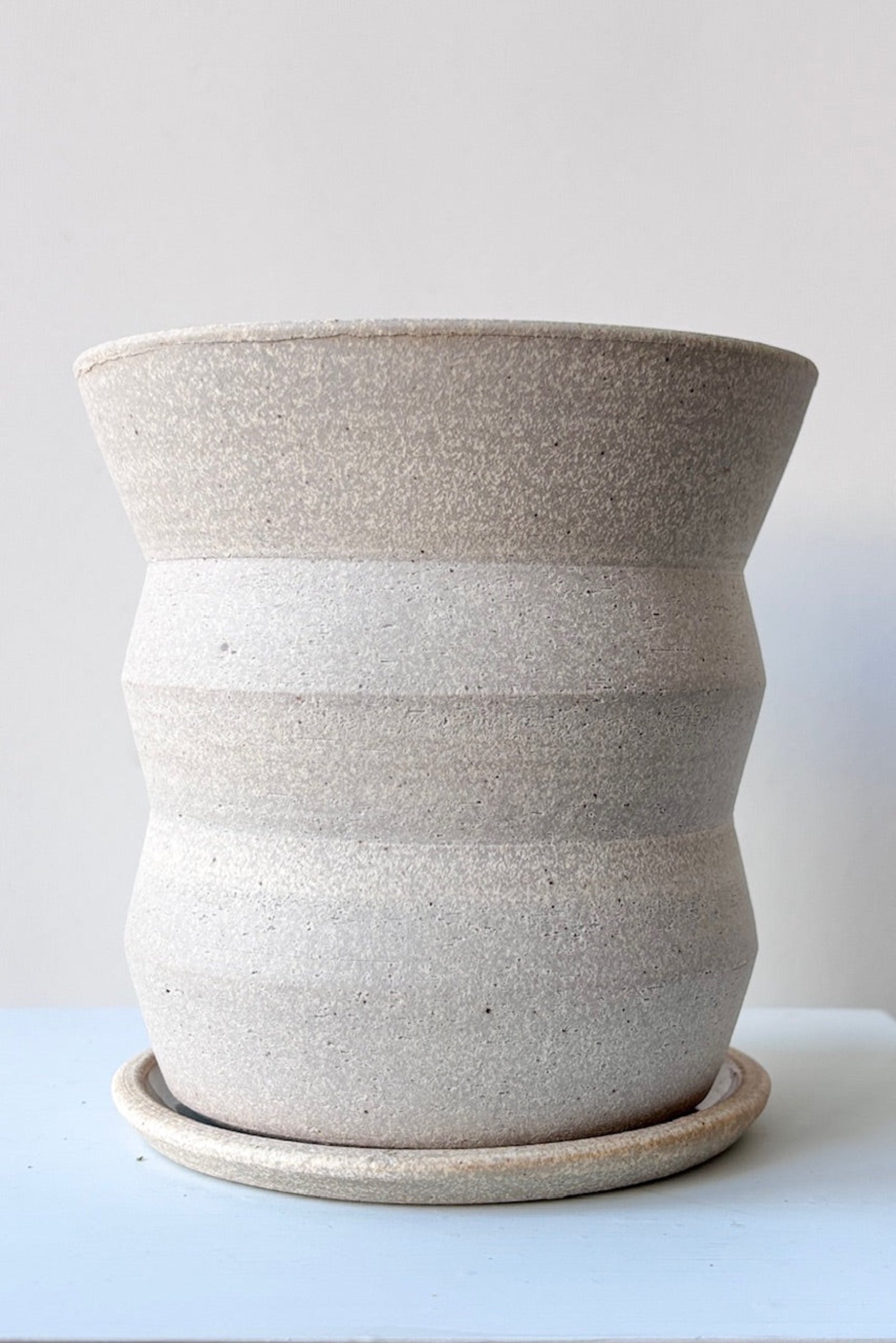 Creme Angled Planter by Olivia Snow Ceramics, empty and viewed from the side. ©Sprout Home