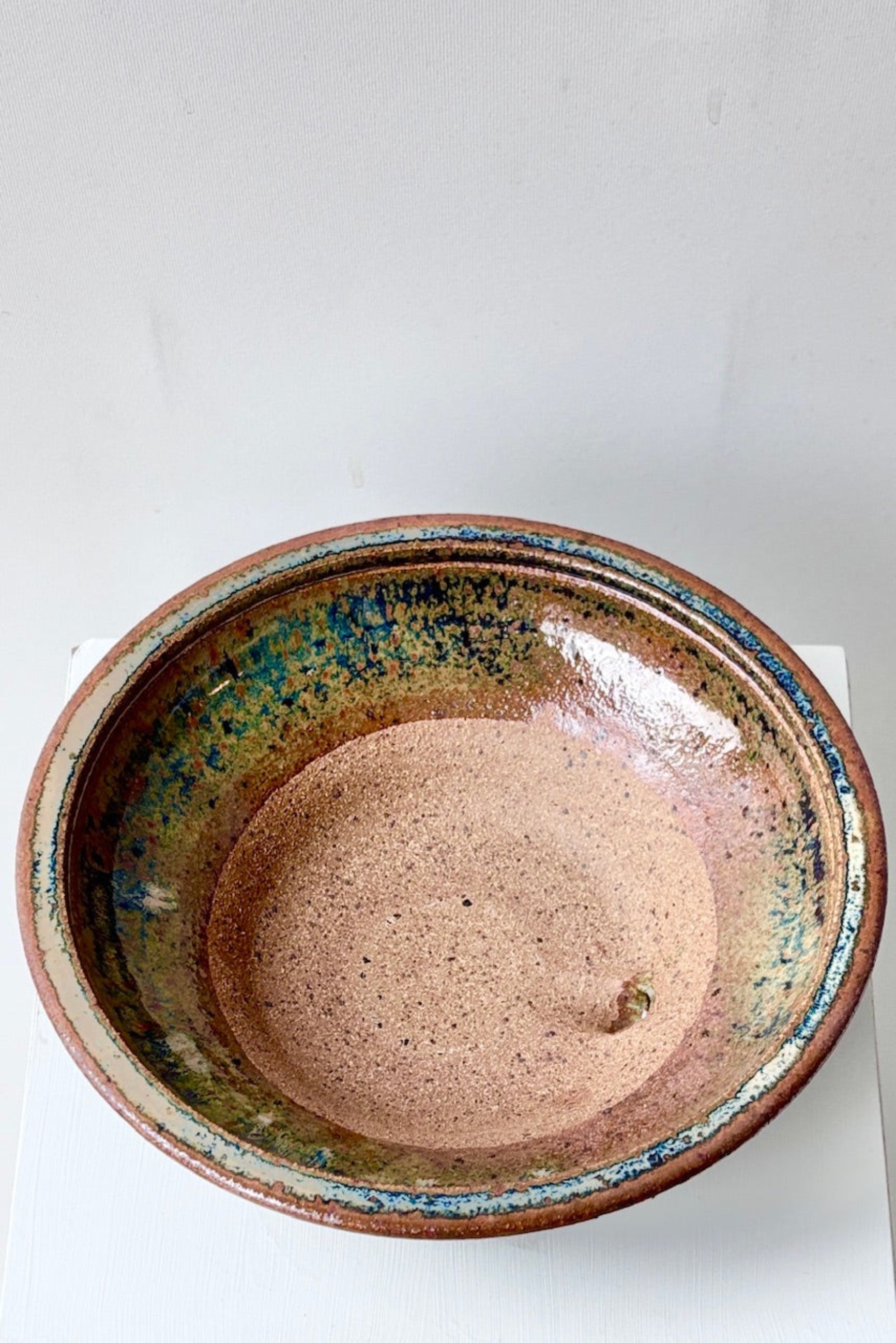 Overhead view of Ivory and Iron small low bowl against a white surface ©Sprout Home 