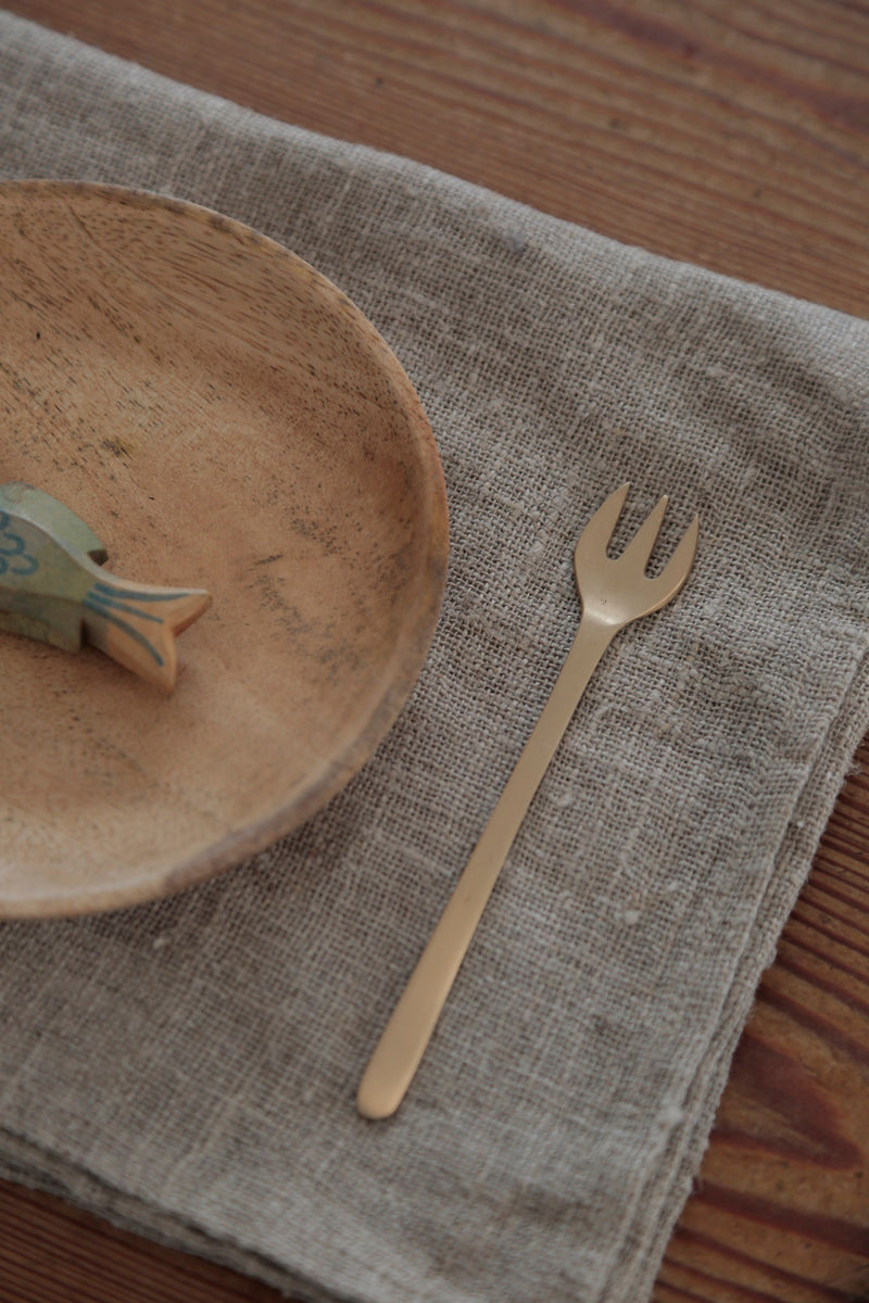 Dessert for by Fog Linen Work to the side of a wooden plate and linen tableset.