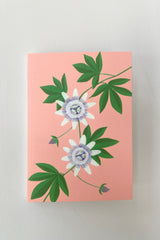 Passion Flower Greeting Card by Stengun at Sprout Home showing the front of the card on a white wall. 