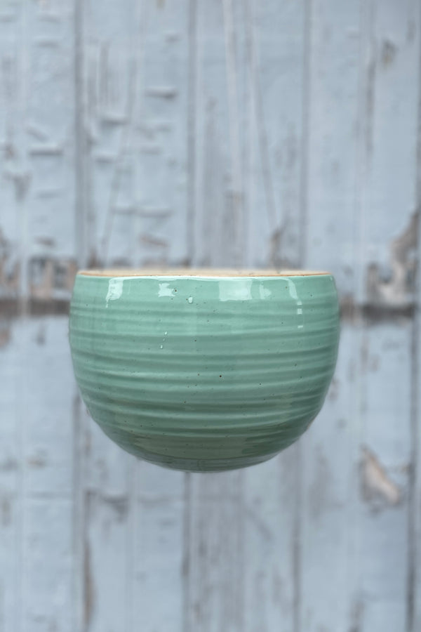 The Celadon Green crackle glazed Spherical Hanging planter empty viewed from the side. 