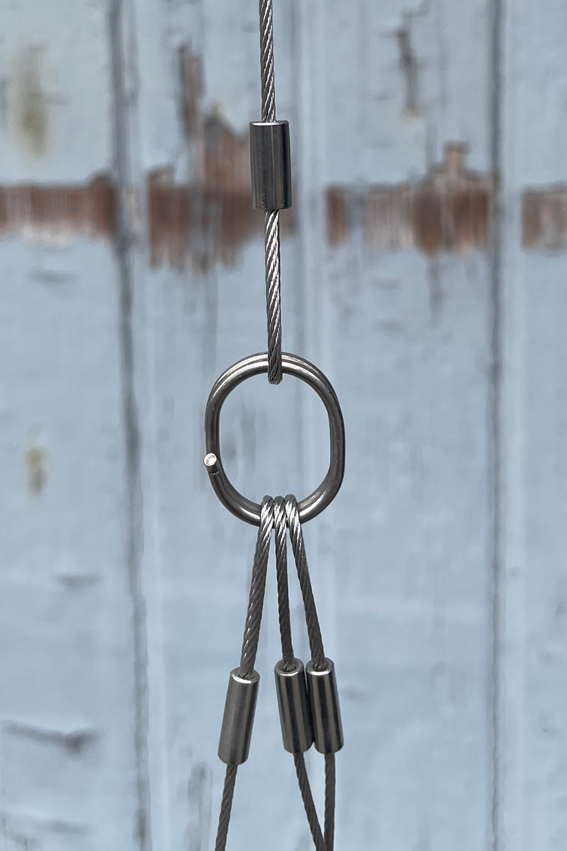 The center ring holding the three lines from the bottom and the extension hook from the top close up used on the Spherical Hanging planters at Sprout Home. 