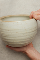 Spherical Hanging Planter
Creamy White Speckle
by Angus & Celeste  being held in hand showing the finish.