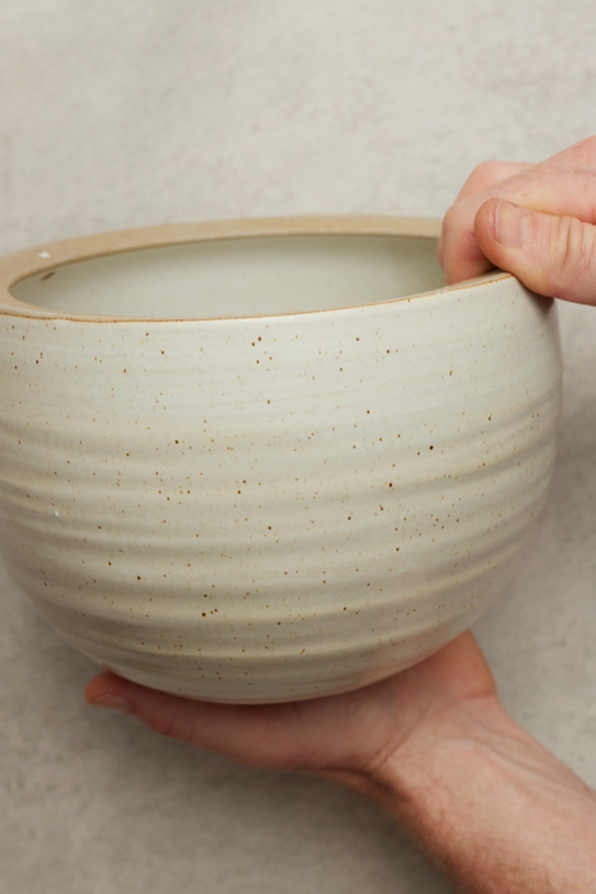 Spherical Hanging Planter
Creamy White Speckle
by Angus & Celeste  being held in hand showing the finish.