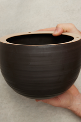 Spherical Hanging Planter
Smooth Matt Black by Angus & Celeste being held in hand to show the glaze.