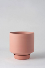 The ochre colored Collectors Gro pot from Angus & Celeste empty and in front of a white wall. 