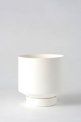 A white Collector's Gro Pot by Angus & Celeste empty and in front of a white wall.