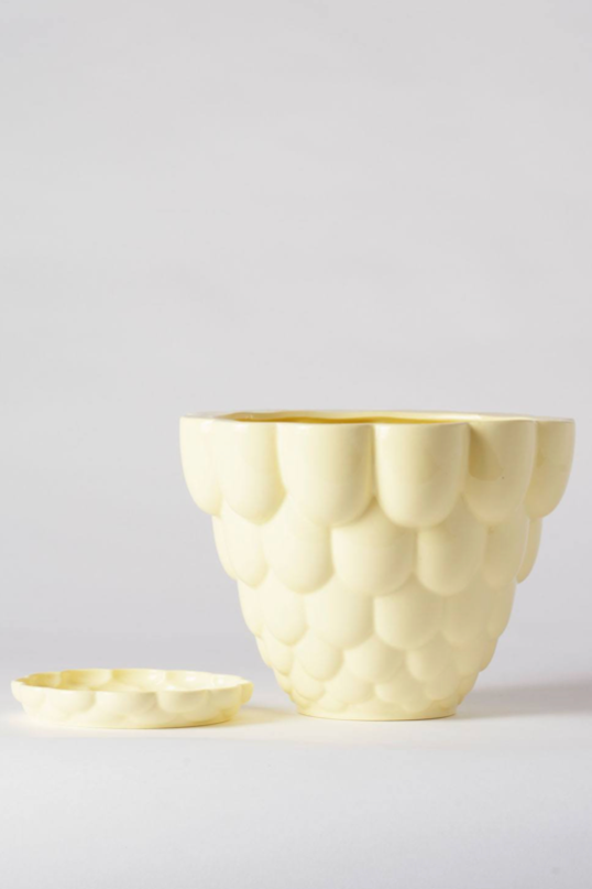 A yellow Jelly Planter by Angus & Celeste shown with its detachable saucer by its side. 