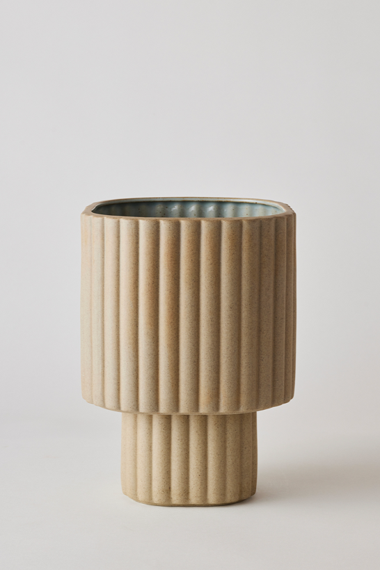 Sand colored Modular Stack planter by Angus & Celeste being shown empty in front of a white wall. 