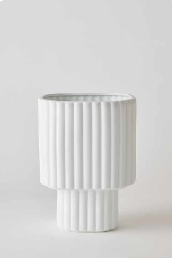 White colored Modular Stack planter by Angus & Celeste being shown empty in front of a white wall. 