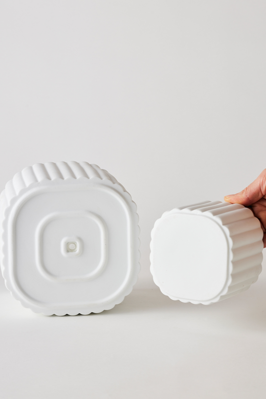 White colored Modular Stack planter by Angus & Celeste being shown with its two parts separated and shown from the bottom of each.