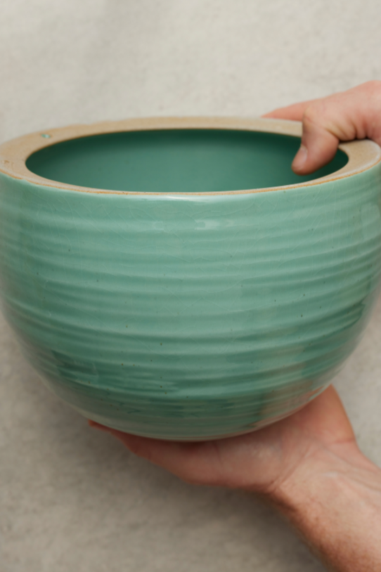 Spherical Hanging Planter
Celadon Green Crackle shown empty being held in hand.