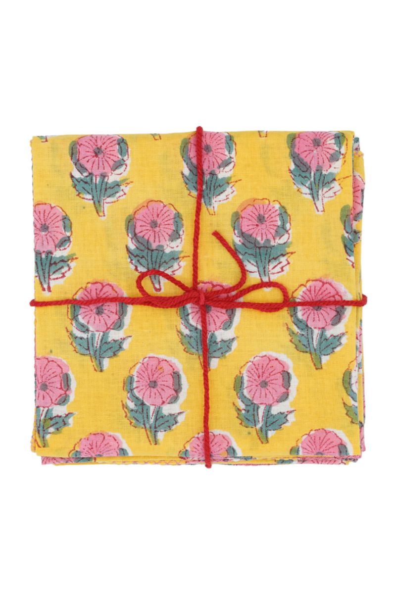 Suzette Cotton Napkins Helenium Lemon folded and tied with a red string. 