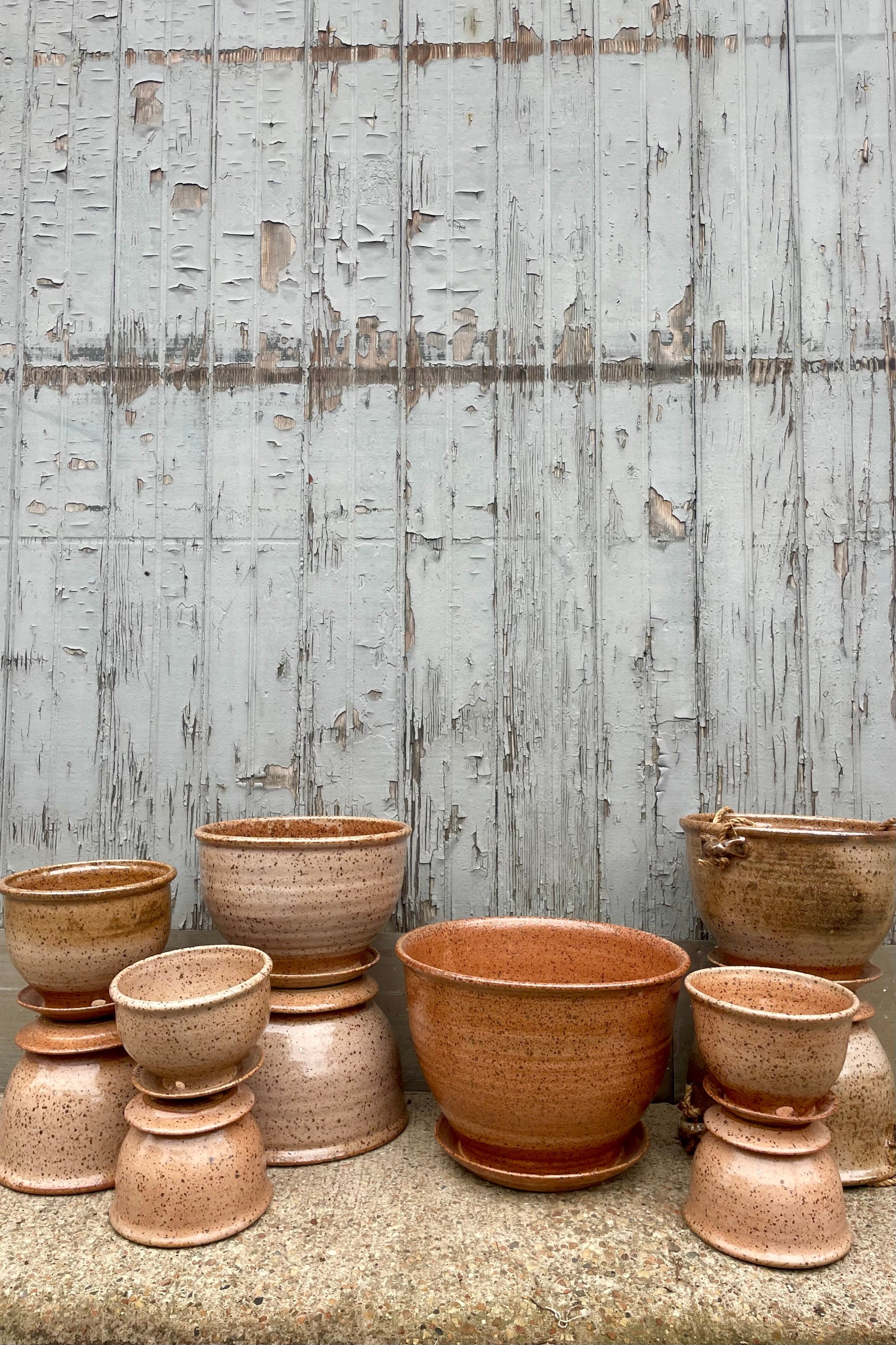 A groupd of glazed pottery in front of a wooden wall ©Sprout Home