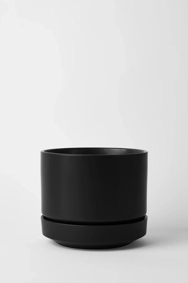 LBE Design Revival Ceramics Round Two Black planter against a white grey wall. 