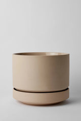 LBE Design Oatmeal Round Two Planter empty and against a light grey wall. 