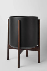 the 12 black cylinder and dark teak stands by LBE Design