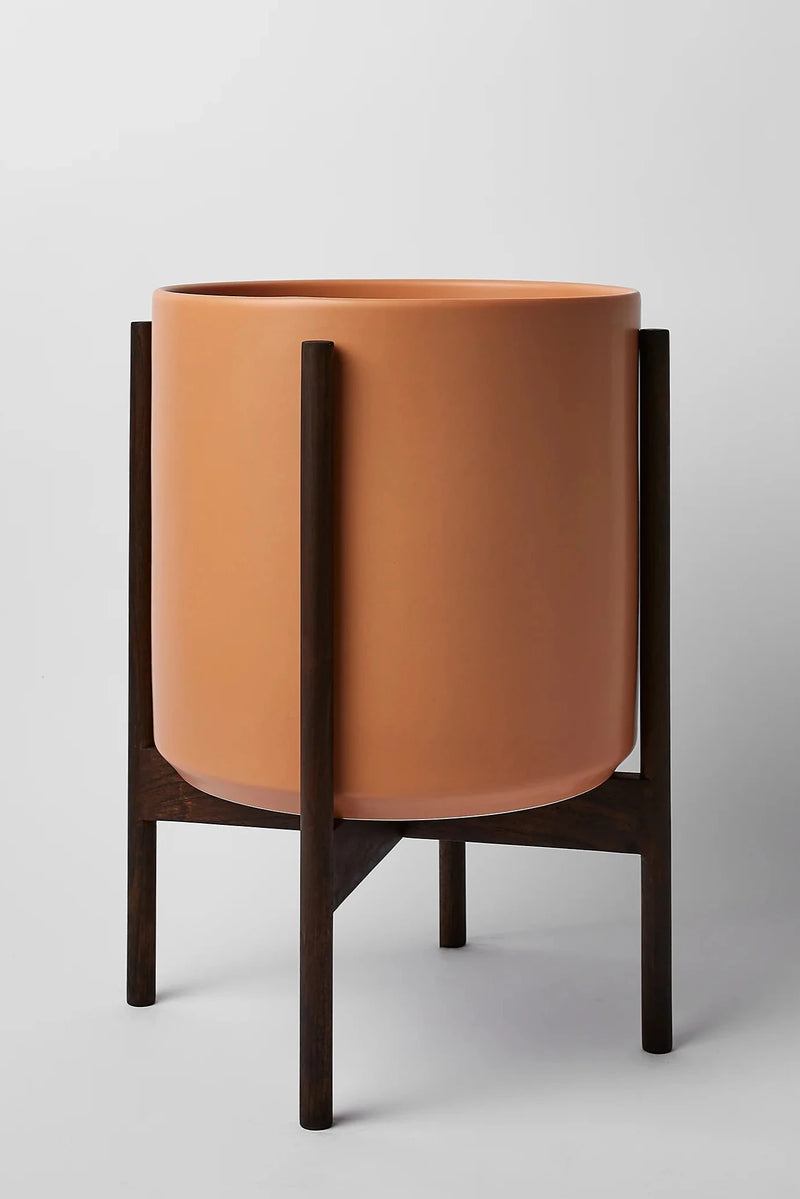 The 12 Peach cylinder pot and dark teak stand by LBE Design.