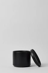 LBE Design Solid Goods Cylinder and saucer black with its saucer leaning on the pot