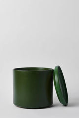 LBE Design Solid Goods Ceramic Cylinder planter and saucer in Forest Green shown with its saucer leaning against the main pot