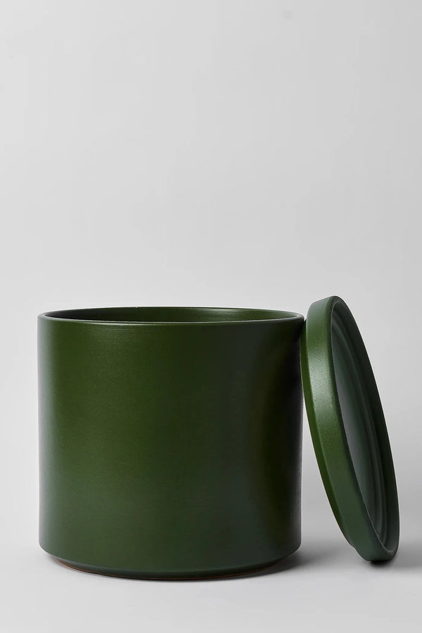 LBE Design Solid Goods Cylinder planter and saucer in Forest Green with its saucer leaning against the empty pot