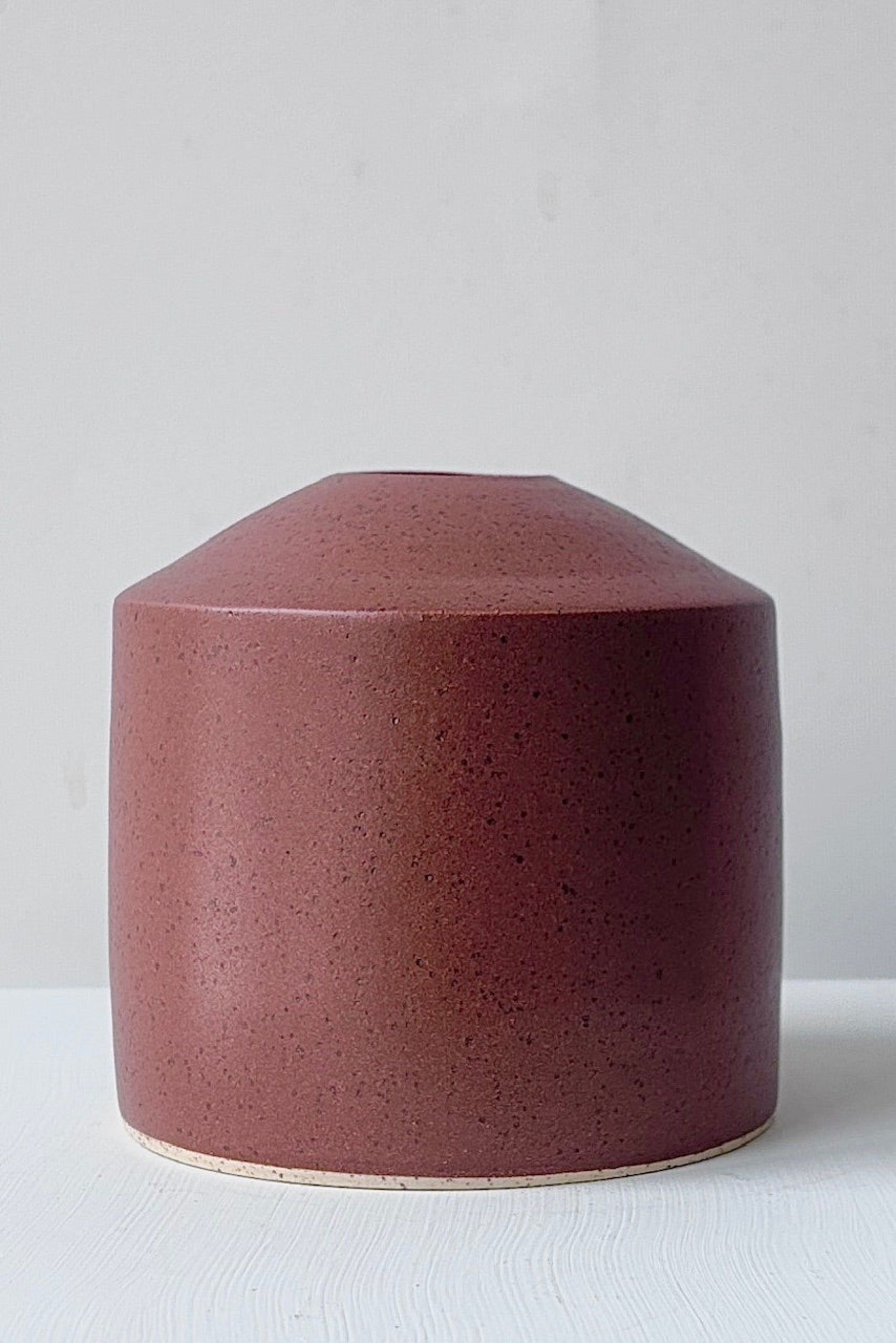 Chocolate speckle siros vase on a white surface in front of a white wall ©Sprout Home