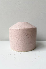 The Pink Speckle Siros vase as Sprout Home against a white wall. 