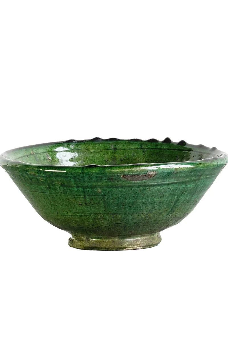 A small green Tamegroute Bowl from the side and against white. 