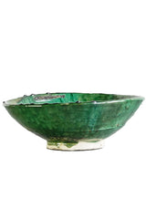 A green Tamegroute bowl shown from the side and on a white backdrop.