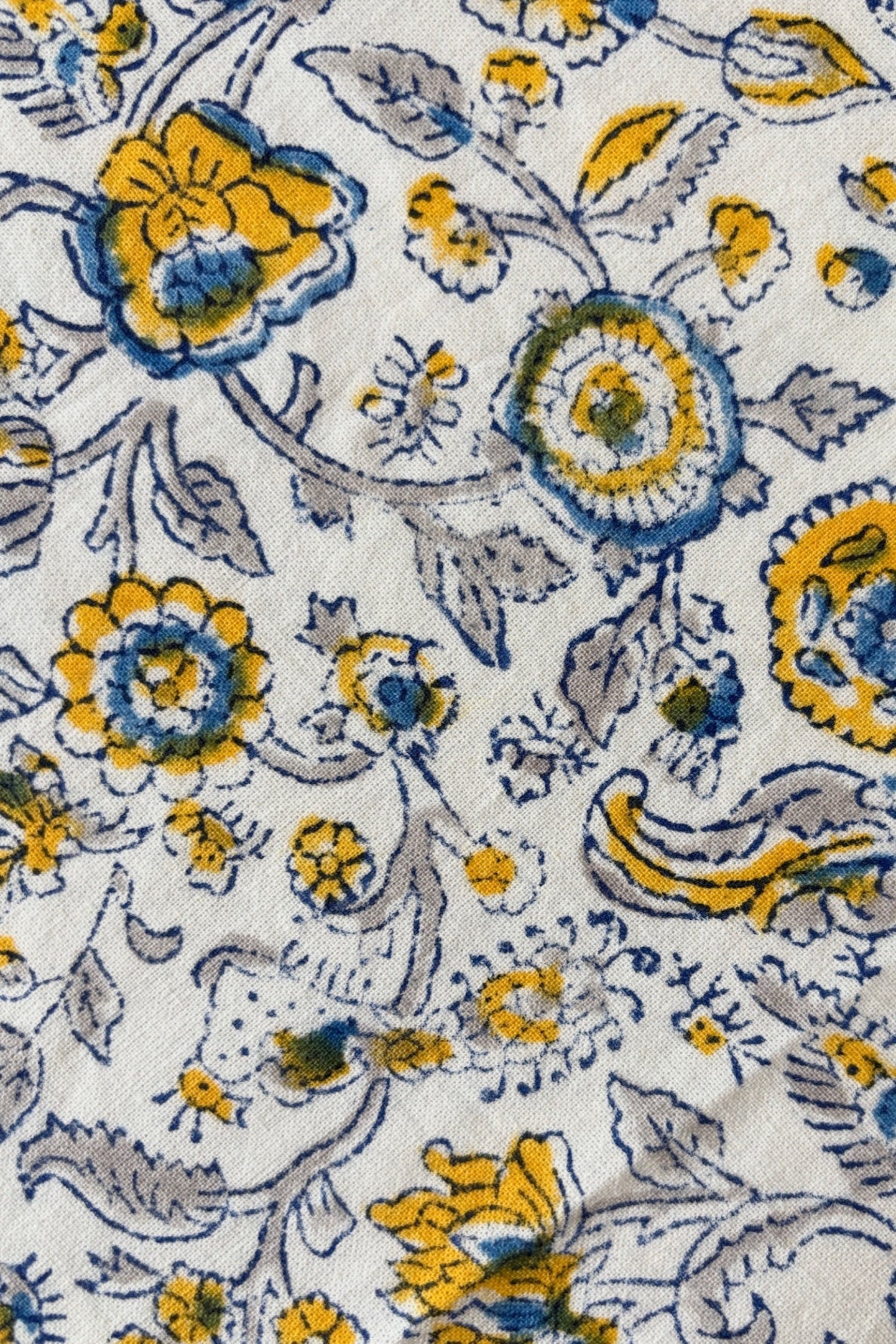 Close up of 100% cotton hand block printed tablecloth with blue and yellow floral motif ©Sprout Home