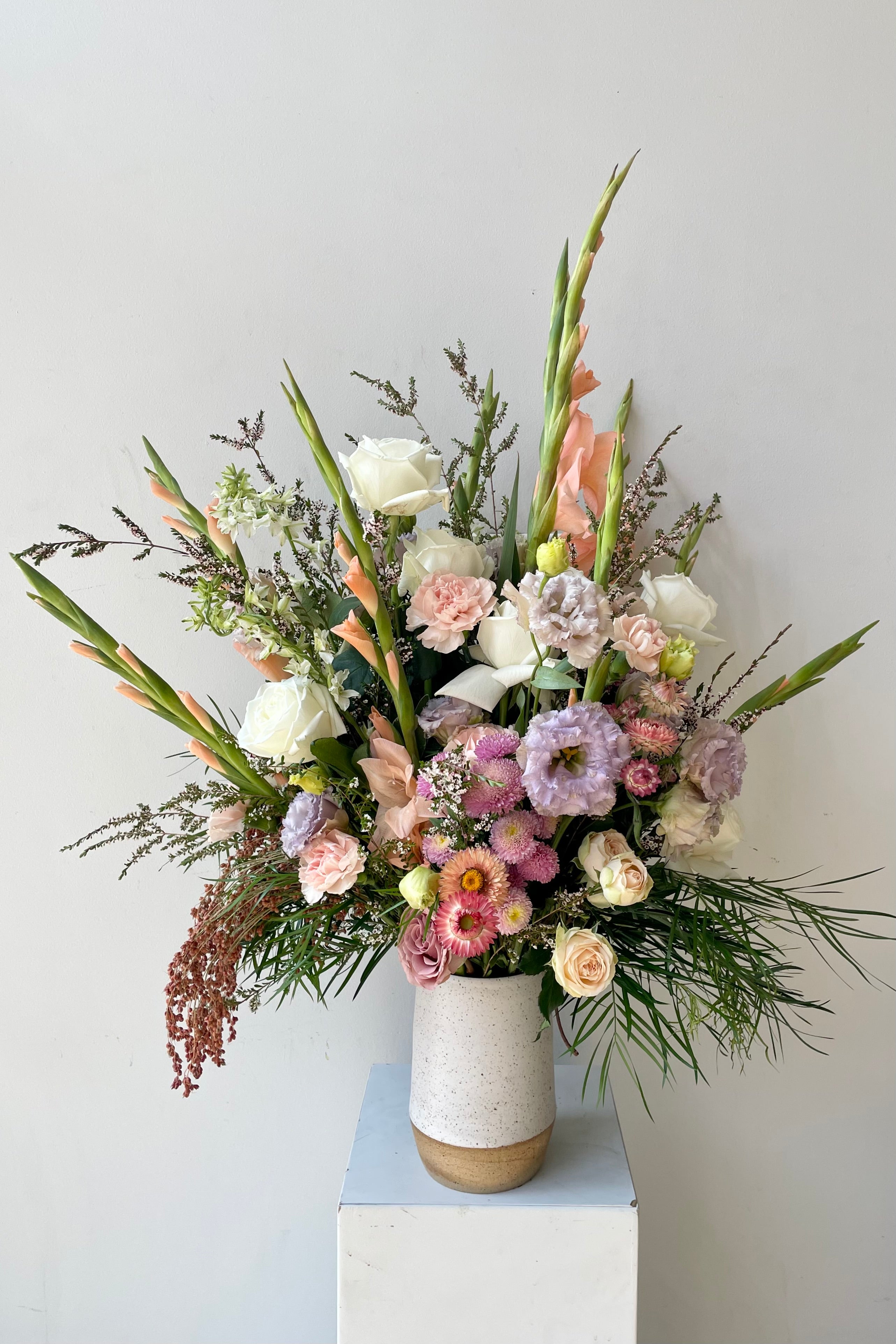 Taller dawn arrangement in August featuring gladiola in a white Sauve vase #size_$200