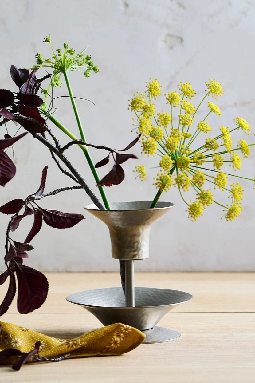 The Floral Stem Holder Small by The Collective housing a branch with burgundy leaves and also flowering Dill. 