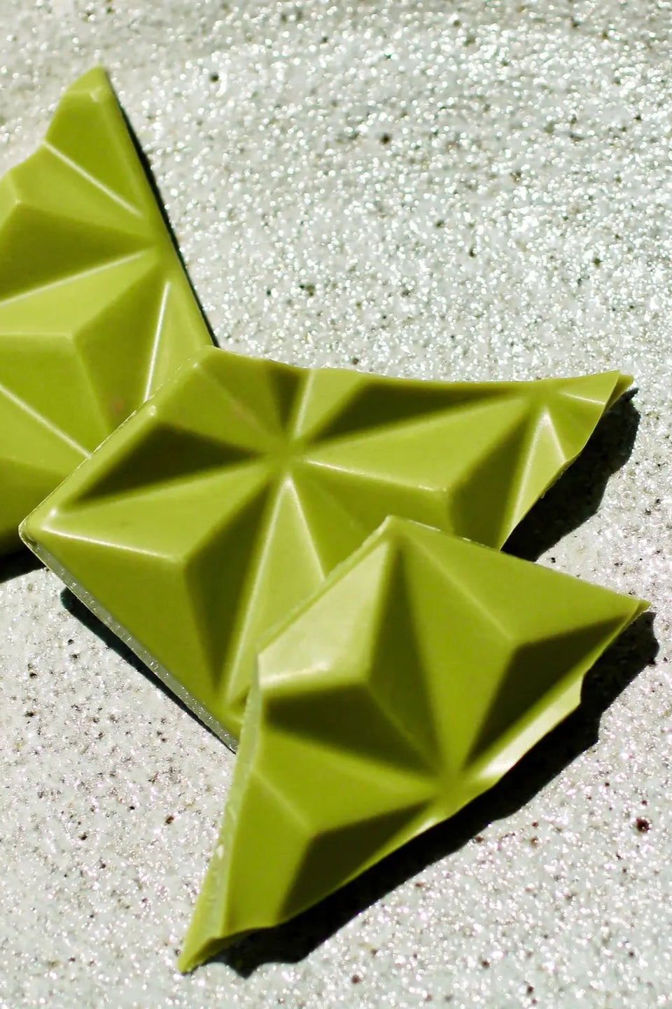 Close photo of green Matcha Chocolate by Deux Cranes. This container Caramelized Sesame.