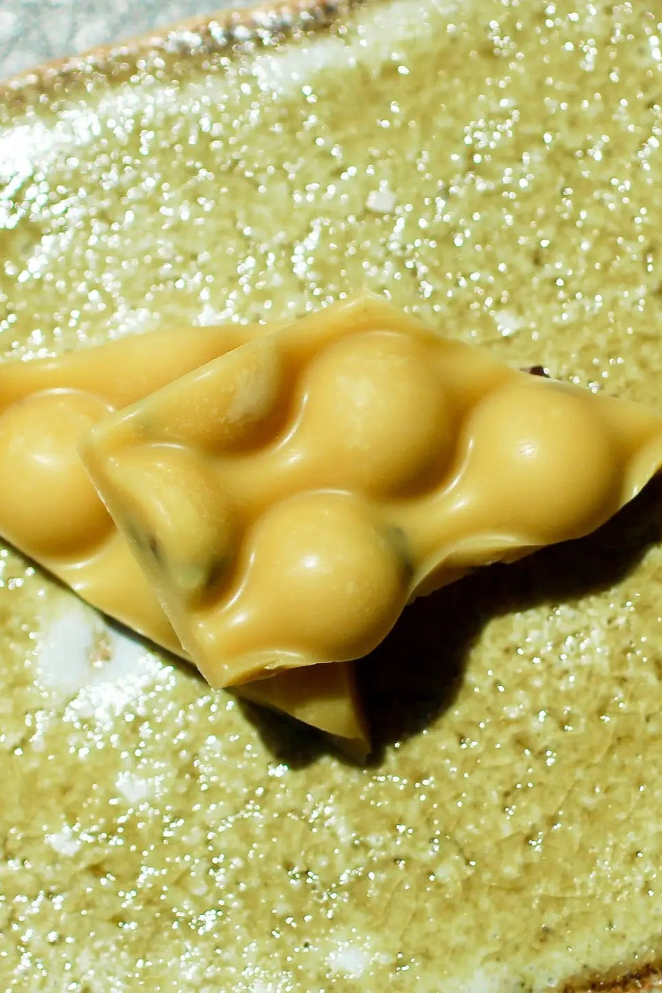 Detail photo of a piece of Passionfruit Chocolate on a coordinating surface.