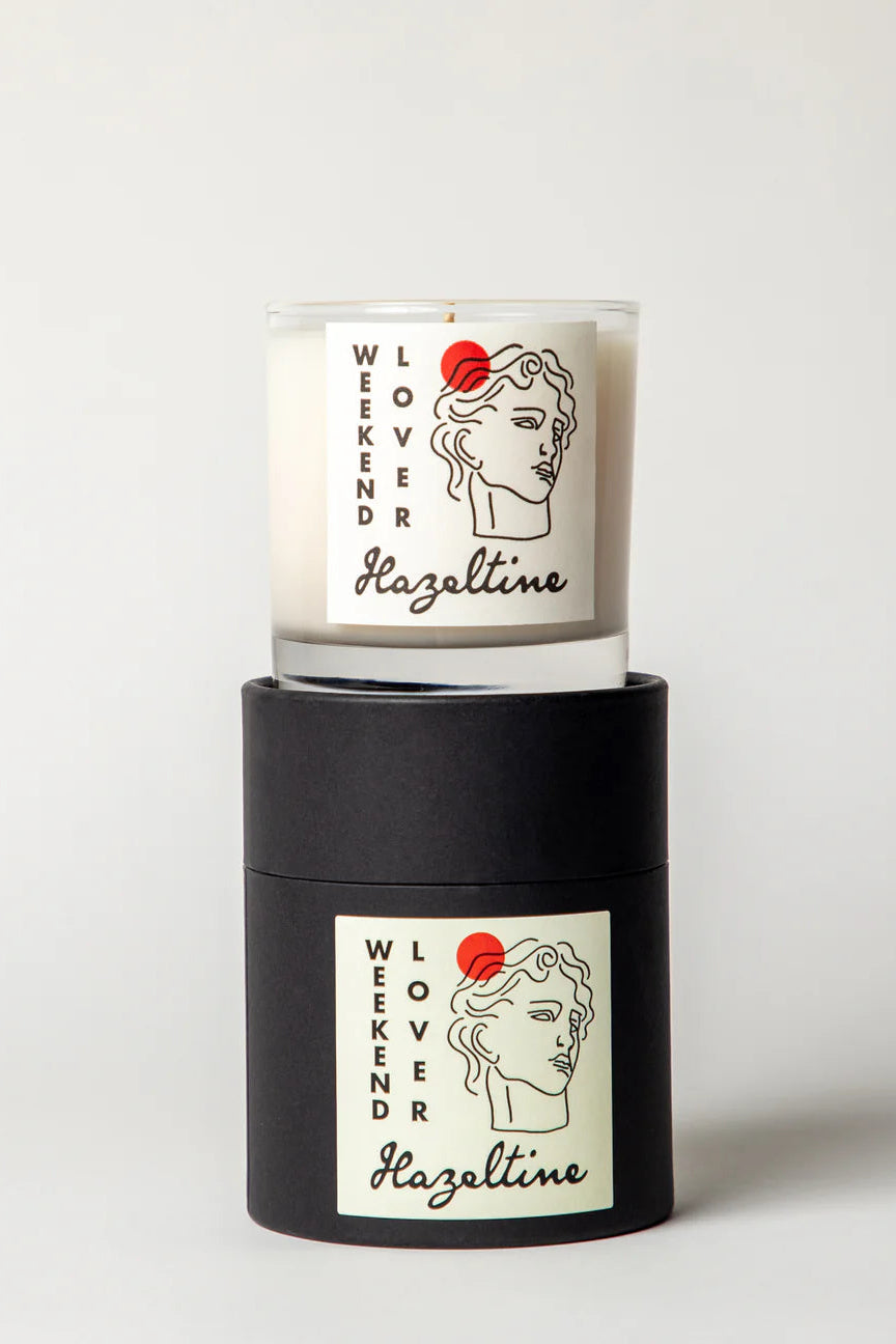 Candle with 'Weekender Hazeltime' branding on a white background ©Hazeltine