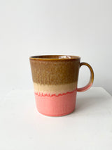 The YT006 Mug with is handglazed rings of pink and brown viewed from the side. 