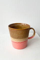 YT006 mug shown from topside with its pink bottom and brown top.