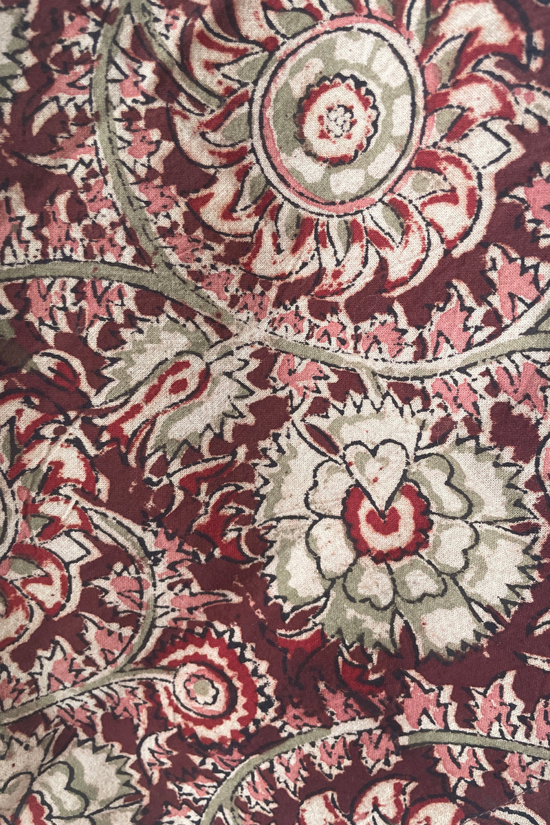 Detail picture of the burgundy, cream, gray and pink floral print of the Adah Napkin in Lela pattern. 