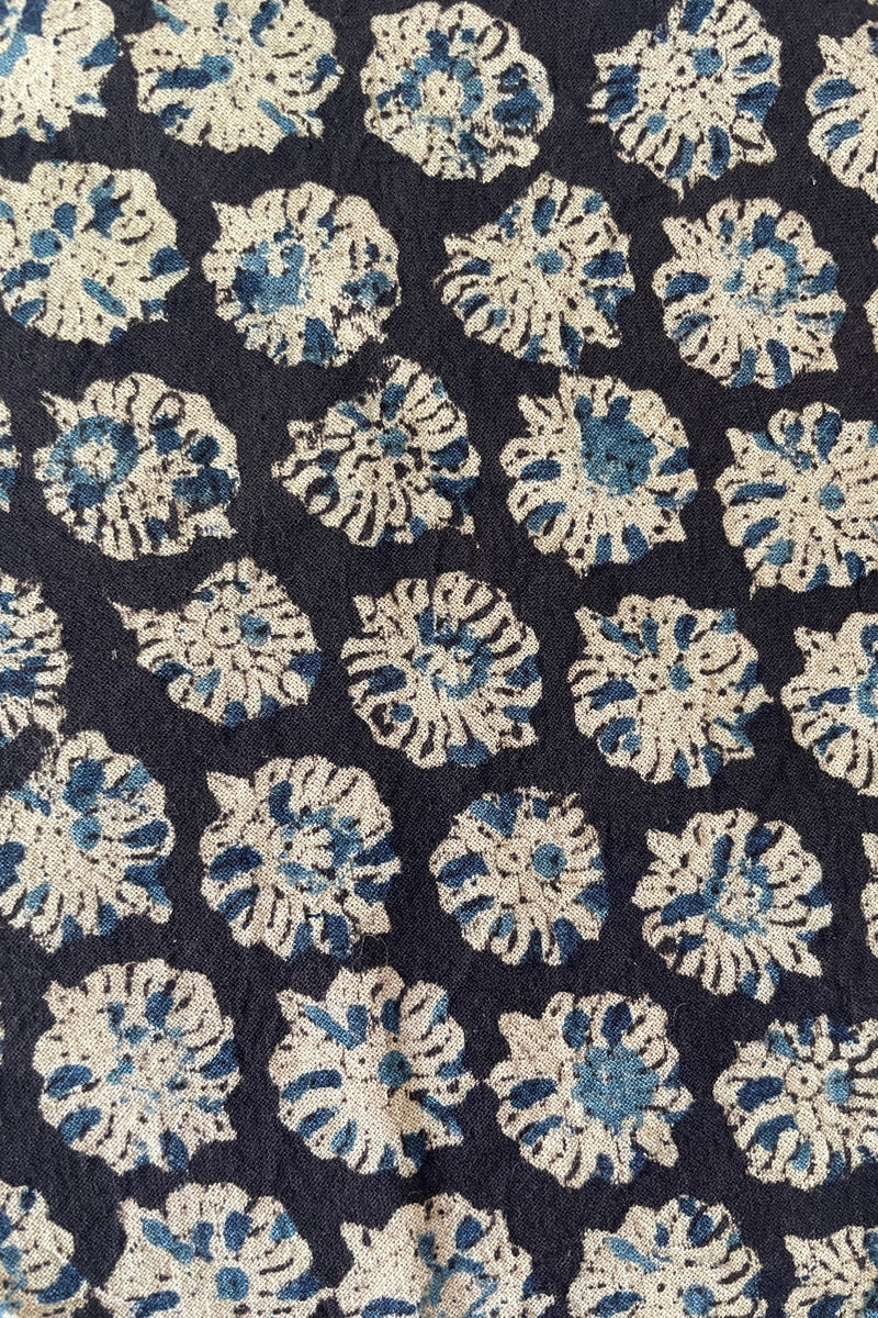 A detail picture of the blue and off-white floral pattern on the Anika Capri napkin
