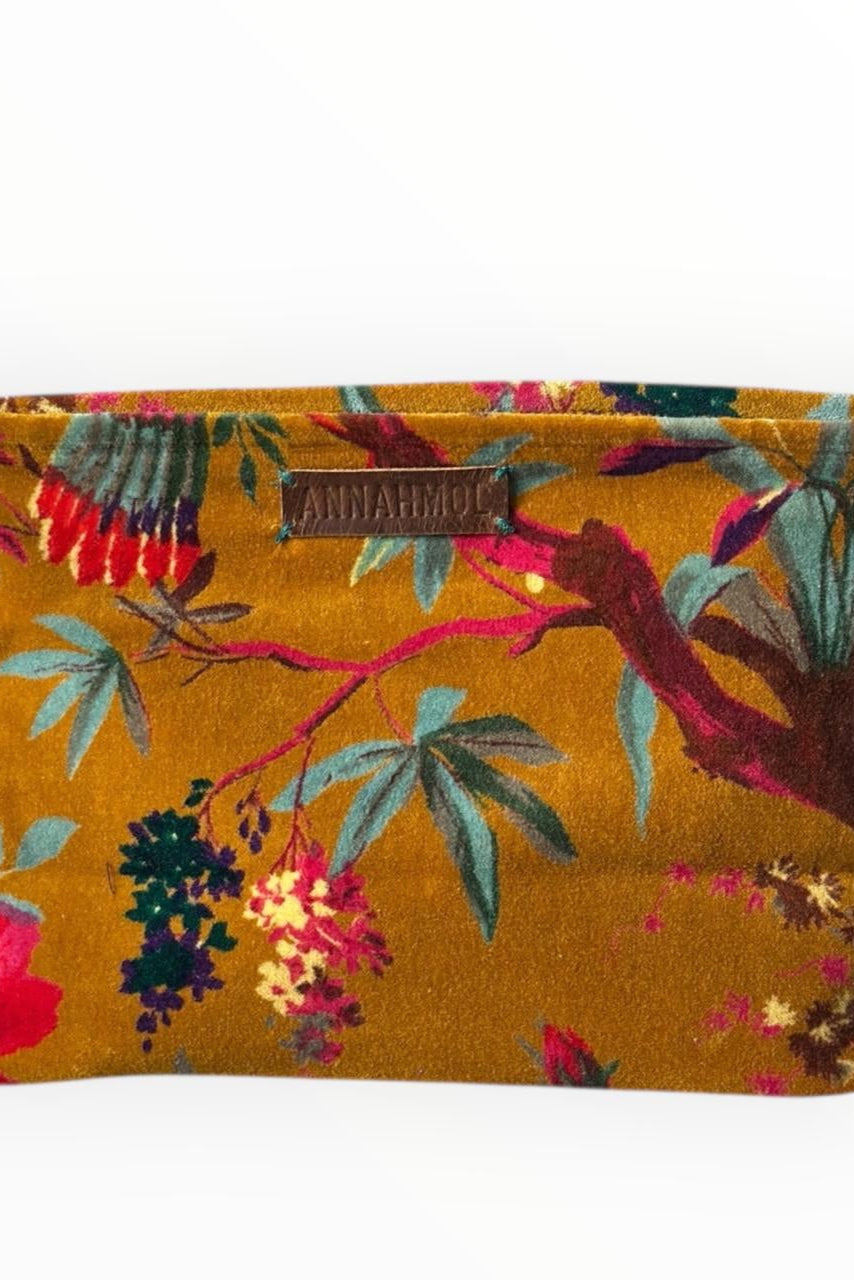 Floral yellow patterned pouch with a brand label on a white background ©Annahmol