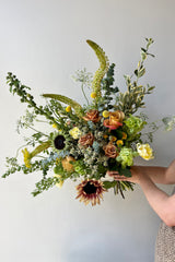 Custom August Champagne Toast arrangement by Sprout Home featuring sunflowers and eremerus. 