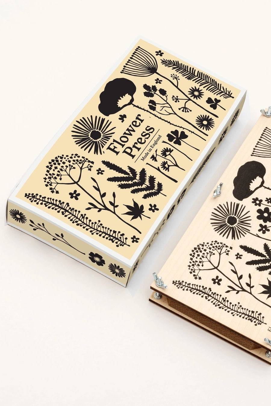  wooden floral press with floral and botanical designs on a white background showing both the press itself and also the packaging ©Studio Wald