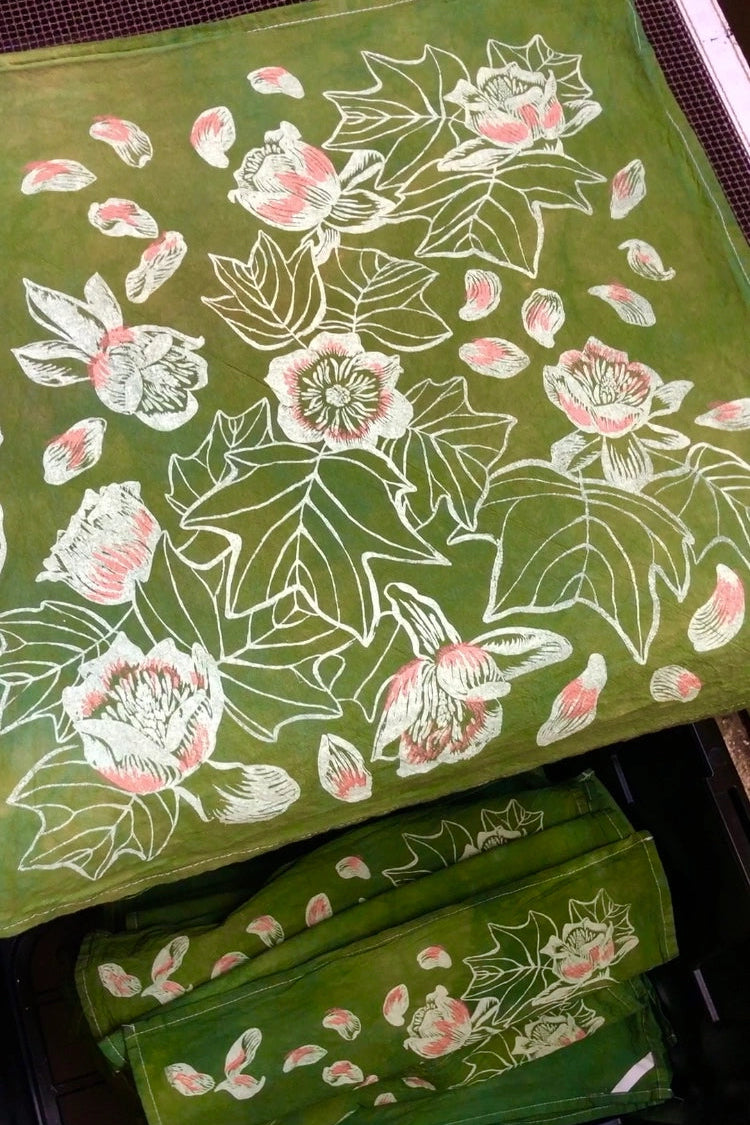 Green hand printed Tulip cloth with floral pattern on a table ©Solstice Handmade