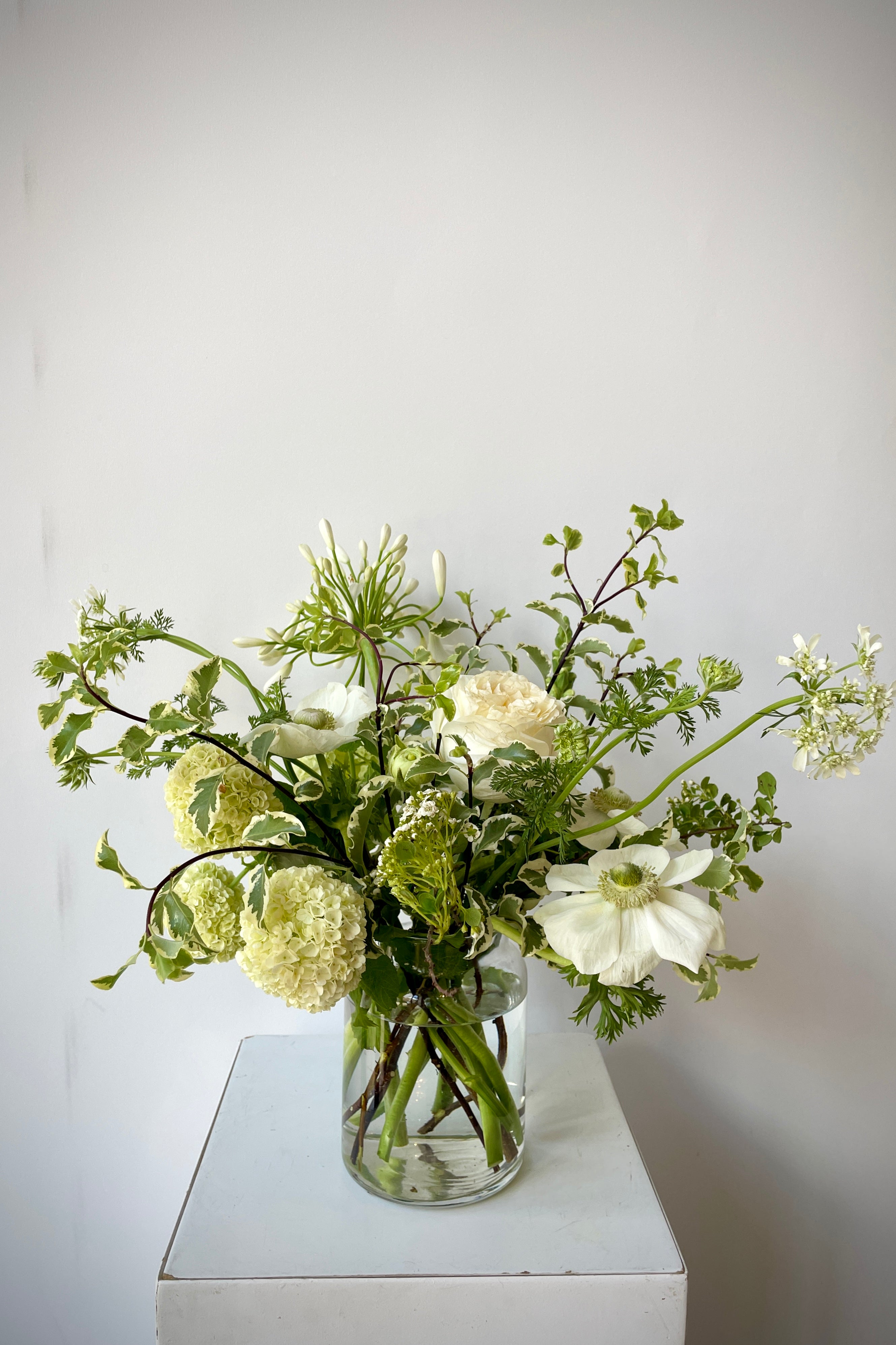 a Sprout Home custom bleached arrangement the beginning of June featuring a white anemone. #size_$65