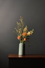 Forest Green bouquet vase with floral inside sitting on a wood credenza by L'Impatience Pottery