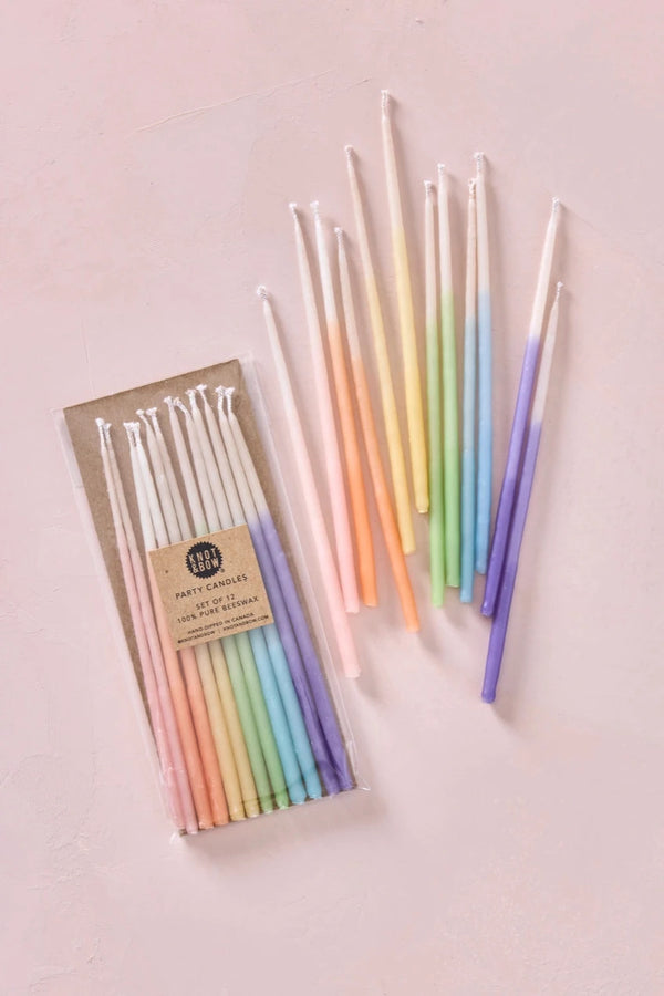 Knot & Bow rainbow ombre tall beeswax candles in their pack and another set out of the package.