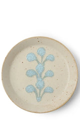 Ivory blue crest plate shown from the topside against a white wall. 