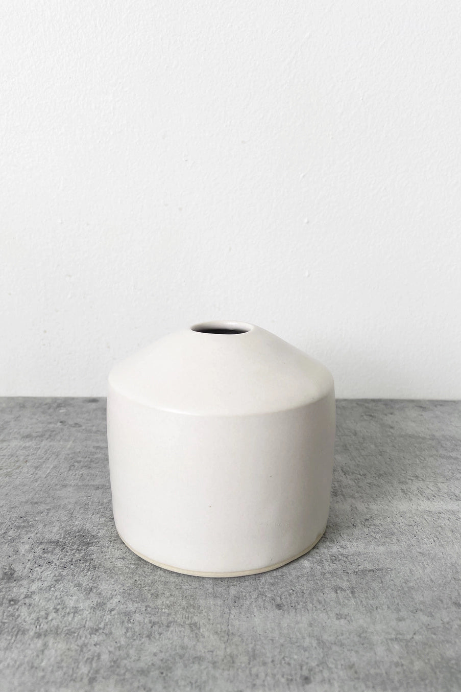 White ceramic Sirosvase on a gray surface with a white background ©Little Fire Ceramics