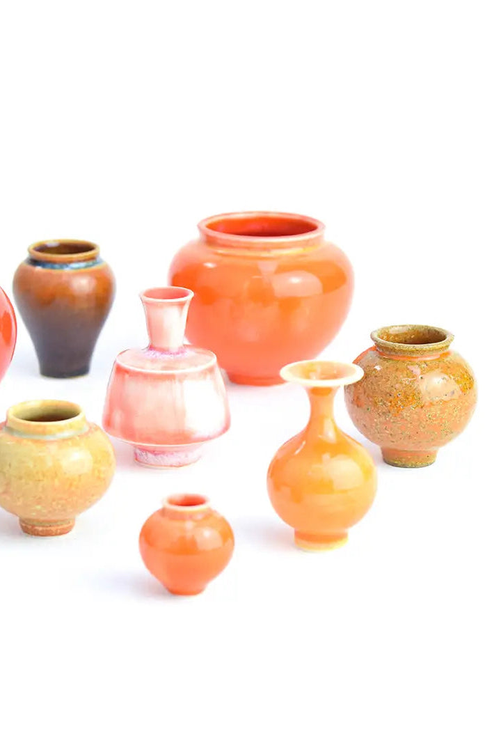 a selection of miniature orange handmade vases ©SGW Labs
