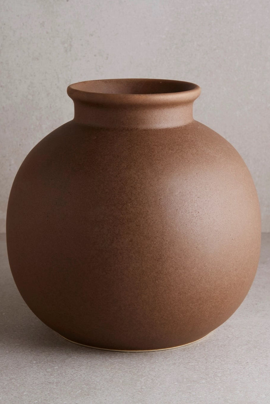 Brown Round Vase viewed from the side on a gray background ©Goodies